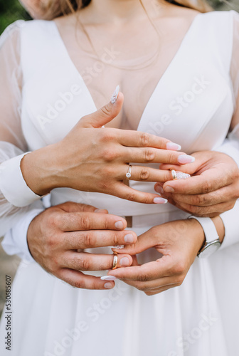 Hands of the bride and groom with golden rings at the ceremony close-up on the fingers. wedding photography.
