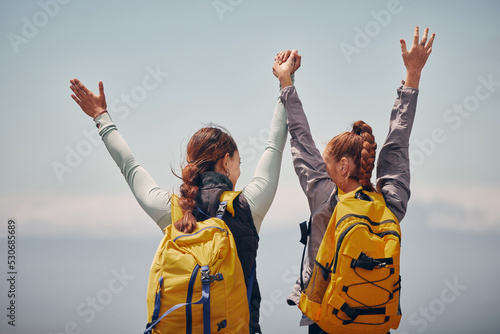 Fototapeta Women outdoor travel, celebrate success adventure and hiking support achievement on mountain top