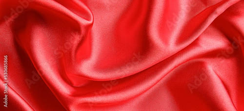 Texture of bright red fabric, top view
