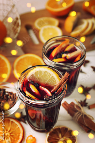 Glasses of delicious mulled wine on table