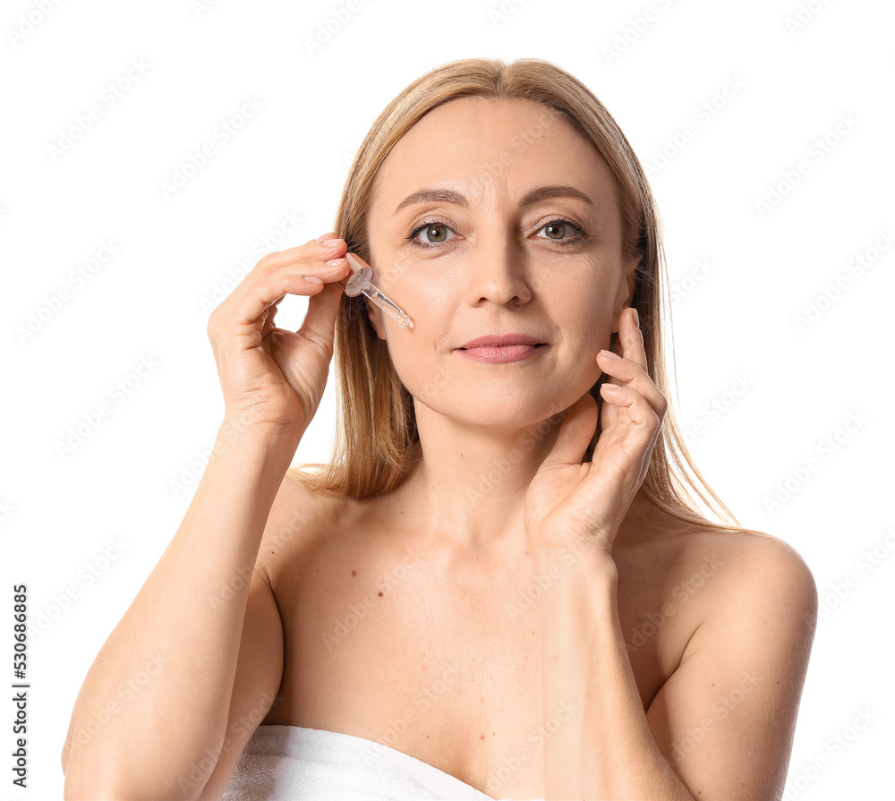 Mature woman with cosmetic serum isolated on white Mature woman with cosmetic serum isolated on white