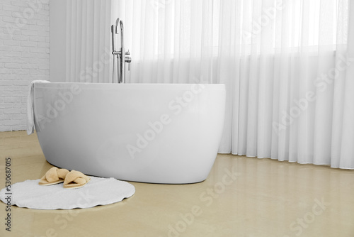 Modern bathtub and slippers...