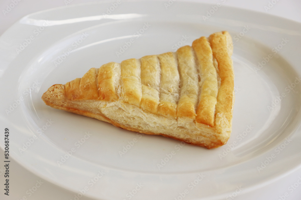 Isolated Apple turnover, croissant, cake. pastry, bakery on the white plate. White background. Top view. Close-up. Copy space Isolated Apple turnover, croissant, cake. pastry, bakery on the white plate. White background. Top view. Close-up. Copy space