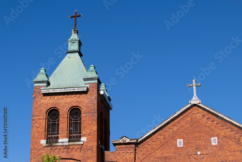 A catholic church bell tower on a blue sky