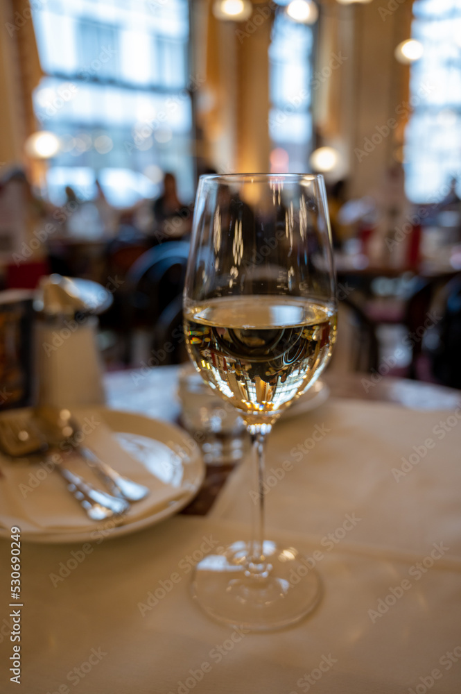 Glass of white dry Austrian wine served in cafe in Vienna, Austria Glass of white dry Austrian wine served in cafe in Vienna, Austria