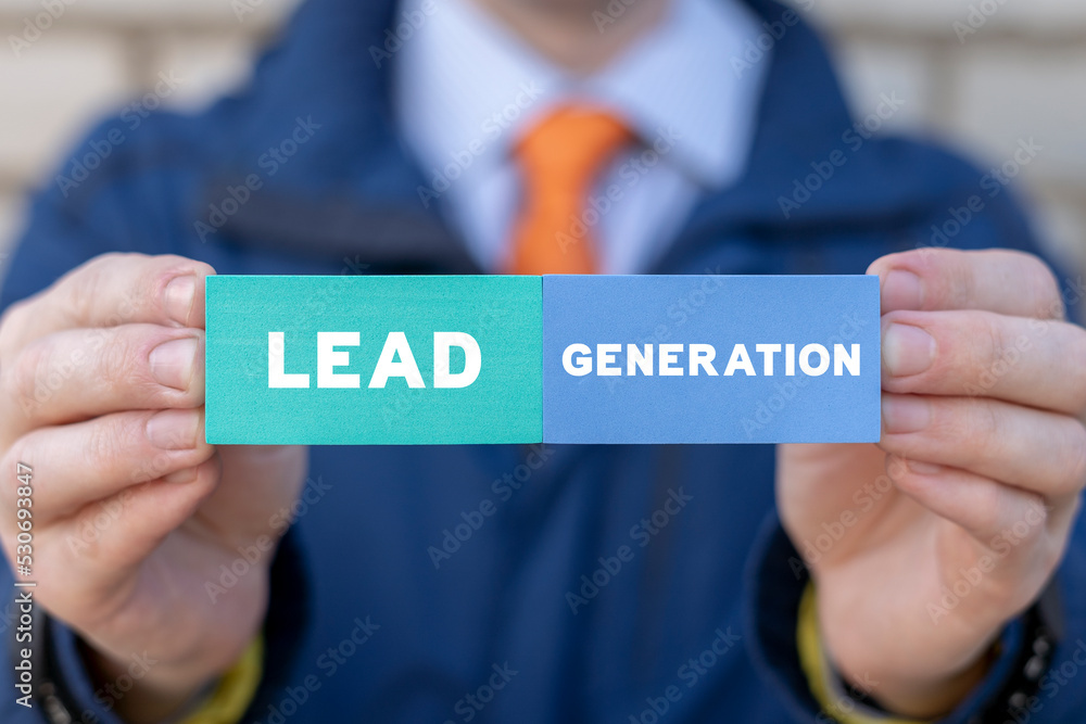 Concept of Lead Generation Business Marketing. Businessman holding colorful blocks with inscription: LEAD GENERATION.