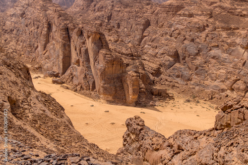 Tire tracks between sandstone cliffs in the desert of al-ula saudi arabia photo