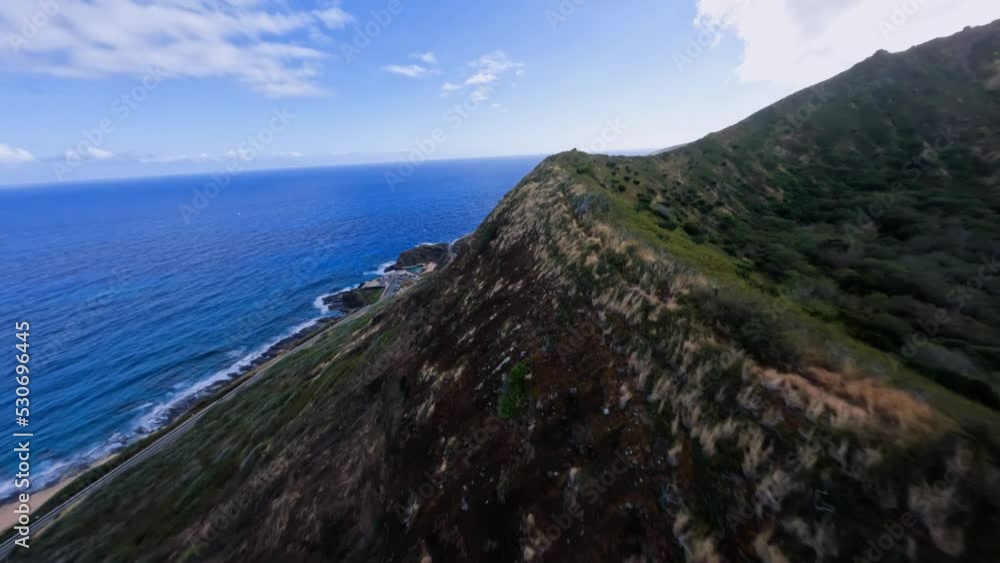 FPV drone shot flying parallel to a crater ridge on the coast of Hawaii, USA - POV aerial FPV drone shot flying parallel to a crater ridge on the coast of Hawaii, USA - POV aerial