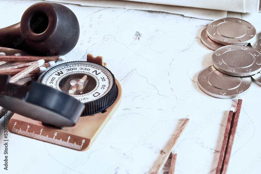 Fototapeta premium Traveler and treasure hunter accessories, map, smoking pipe, pirates coins. Retro fantasy and adventures backgrounds