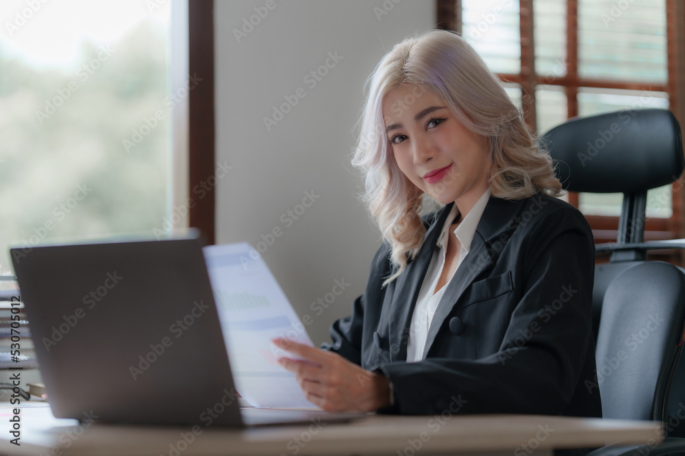 Bookkeeper or financial inspector auditing many financial document at office Bookkeeper or financial inspector auditing many financial document at office