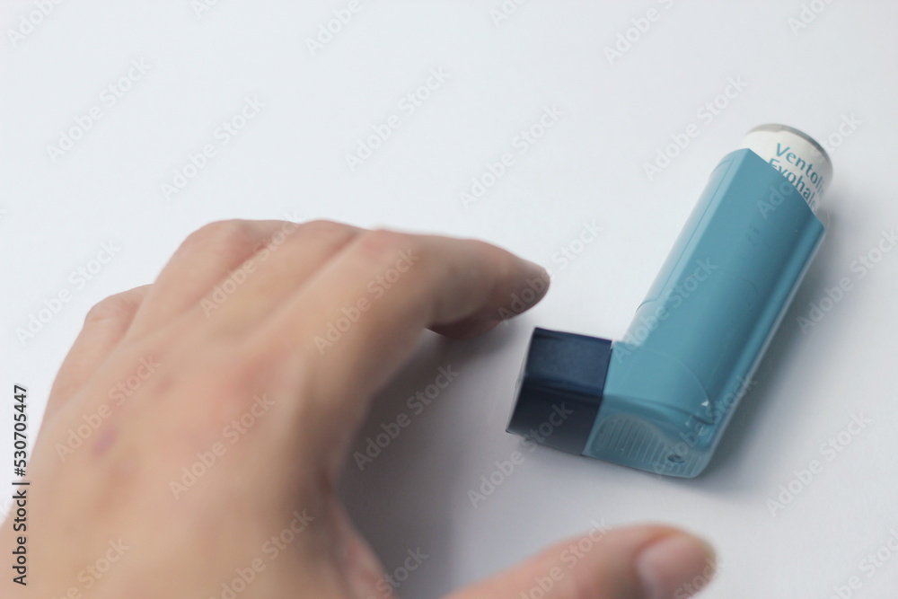 Bangkok, Thailand September 2022 Man's hand picking up asthma