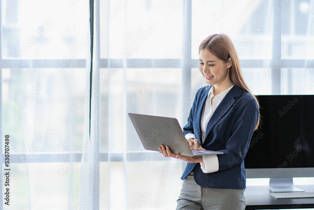 Asian women work online at home using laptop computers to work, surf the web and greet people via video calls. Asian women work online at home using laptop computers to work, surf the web and greet people via video calls.