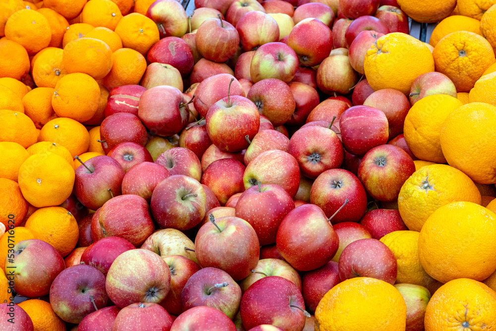 Apples and oranges for sale at a market Apples and oranges for sale at a market