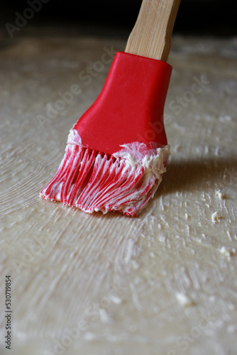 Obraz na plátne close up of raw dough being brushed with butter