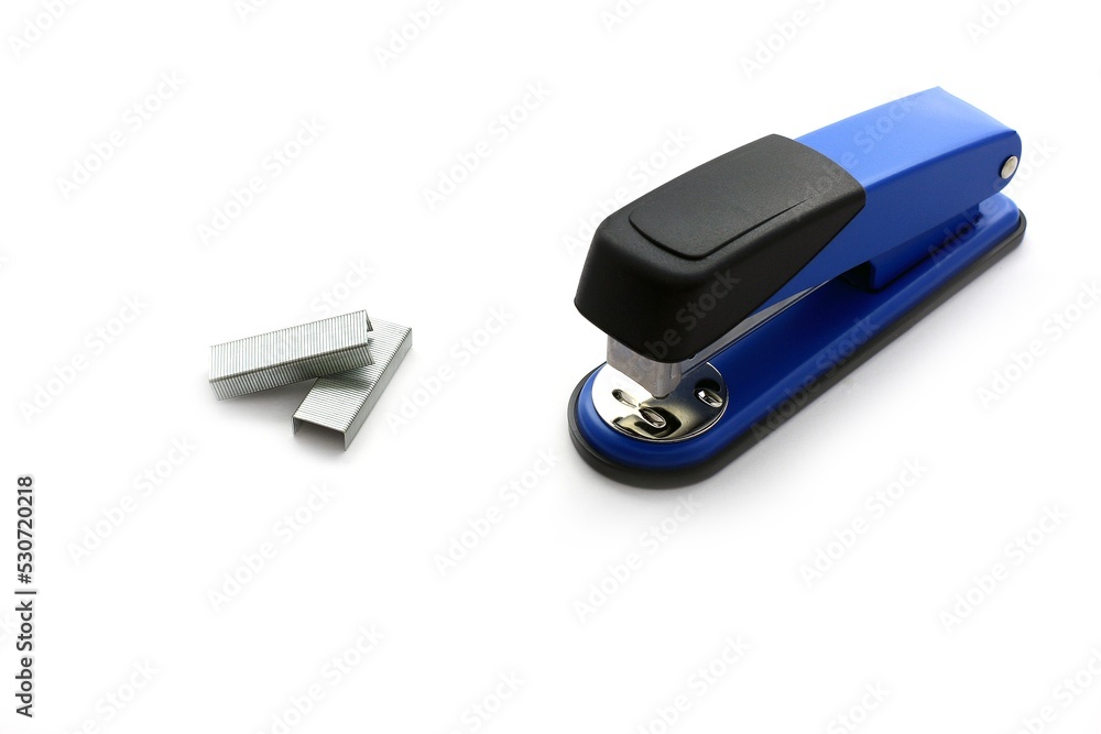 Metal Staples and blue Stapler on the white background Metal Staples and blue Stapler on the white background