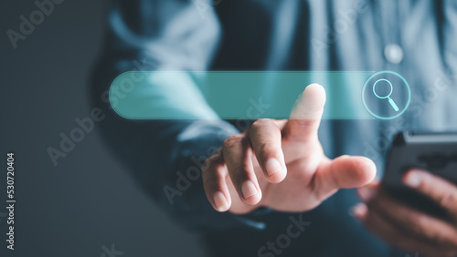 search technology Search Engine Optimization, Man's Hand Pointing to Internet Search Icon, Using Search Console on Your Website, Connecting and Searching Big Data Worldwide via Keywords.