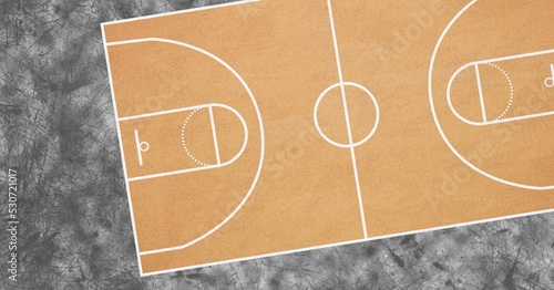 Composition of brown and white basketball court overhead view over textured black background