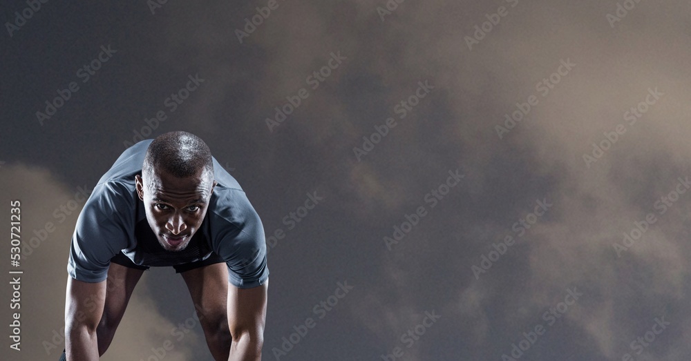 Composition of male rugby player over blue sky with clouds