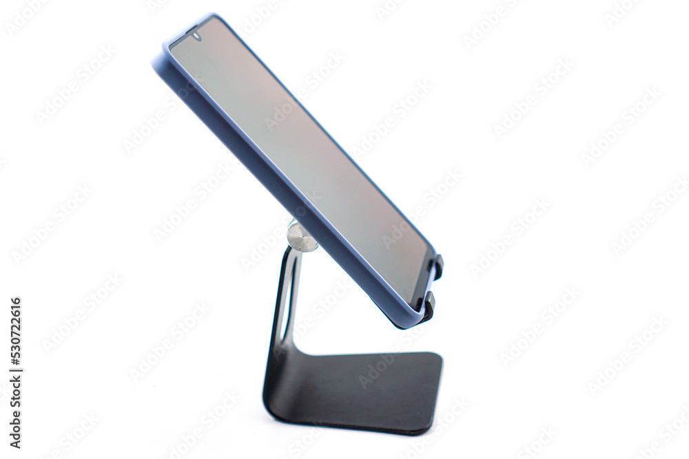 phone holder desk black aluminum metal with smartphone isolated on white phone holder desk black aluminum metal with smartphone isolated on white