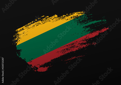 Abstract creative patriotic hand painted stain brush flag of Lithuania on black background