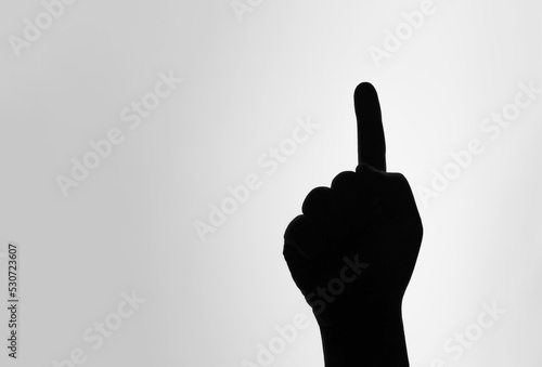 Believe in one God. One finger symbol. The silhouette of raising hand sign and pointing above.