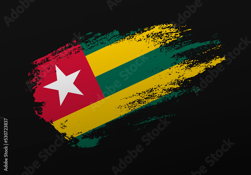 Abstract creative patriotic hand painted stain brush flag of Togo on black background