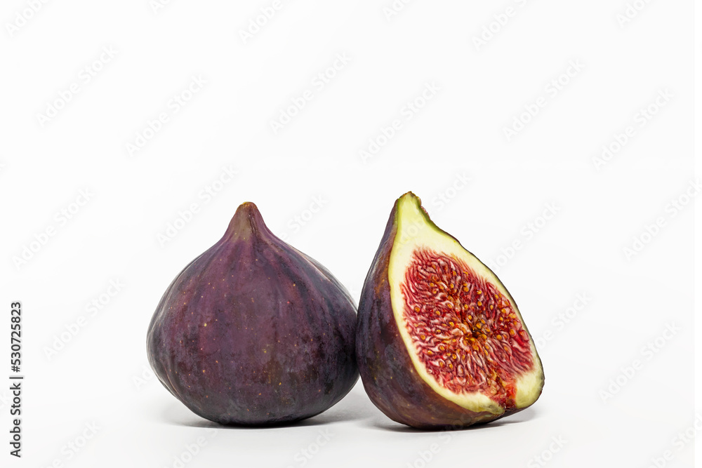 Ripe figs and half of the fruit on a white background. Ripe figs and half of the fruit on a white background.