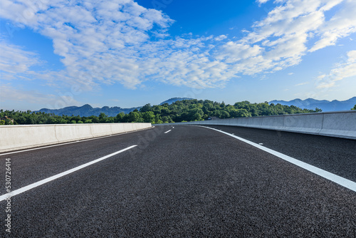 Asphalt road and green mountain natural background