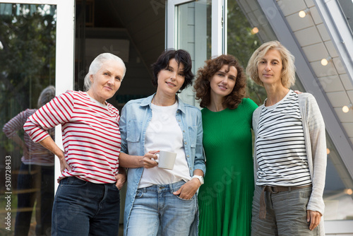 mixed age group women friends having fun together  outdoor. healthy lifestyle. diverse friendship. elderly woman along with adult daughters near her home © ulza