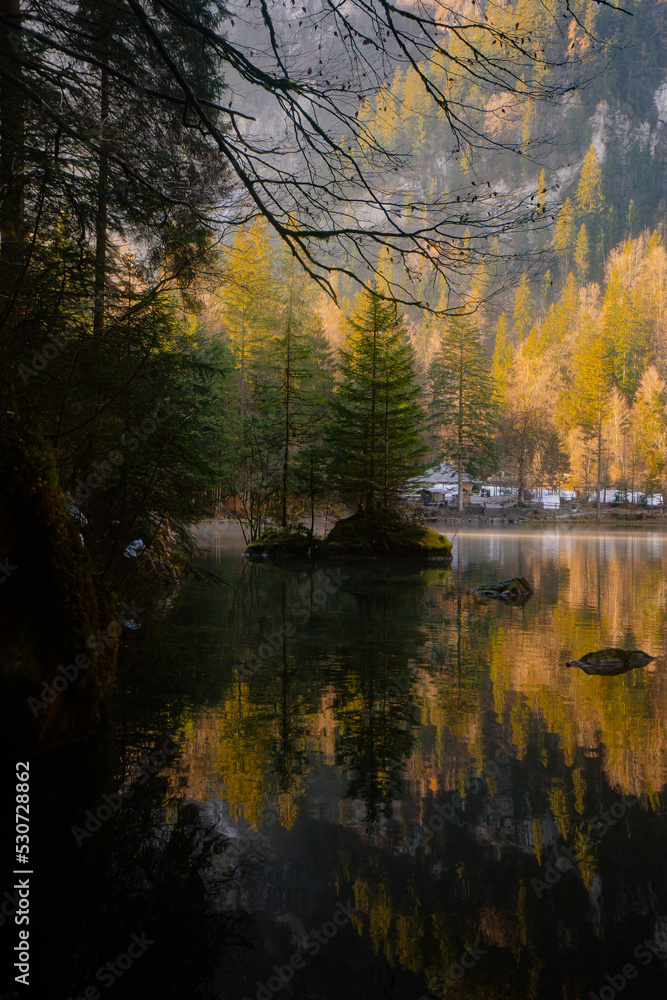Blausee , beautiful turquoise nature lake in Bernese Oberland, Kandergrund during autumn , winter morning : Blausee , Switzerland : December 4 , 2019 Blausee , beautiful turquoise nature lake in Bernese Oberland, Kandergrund during autumn , winter morning : Blausee , Switzerland : December 4 , 2019