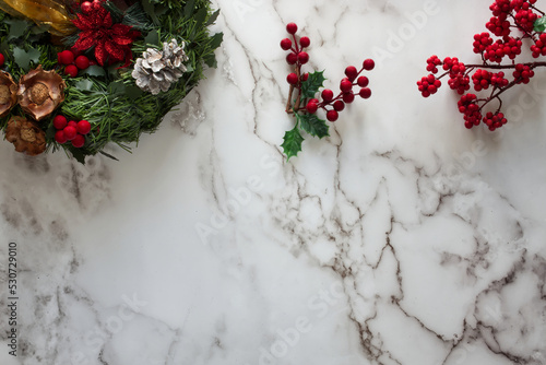 Directly above shot of Christmas decorations on marble table.