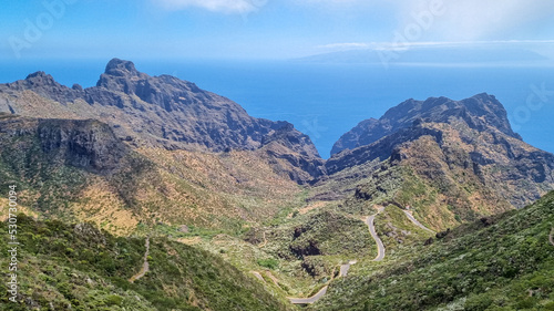 Scenic view on the steep canyon of Teno mountain massif, Tenerife, Canary Islands, Spain, Europe. Hiking trail between village Masca and Santiago del Teide. Mountain road next to Roque de la Fortaleza