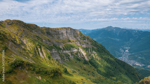 Alpine Meadows Trail, Krasnaya Polyana Resort. Alpine Meadows Walking Route. Aerial view of the green mountain valley, surrounded by high mountains.