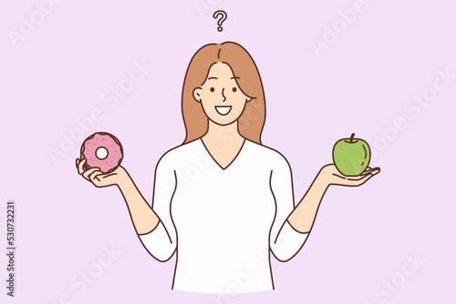 Smiling woman choose between healthy and unhealthy food
