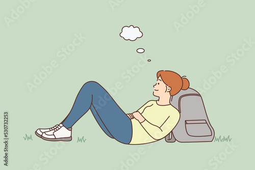 Woman lying on ground dreaming 