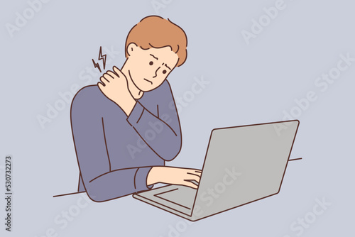 Tired man suffer from backache working on computer 