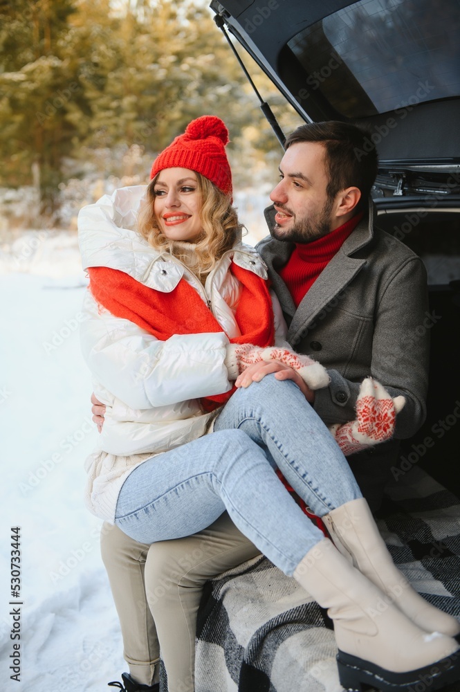 Photo of young attractive couple happy positive smile look each other enjoy time together forest winter love story