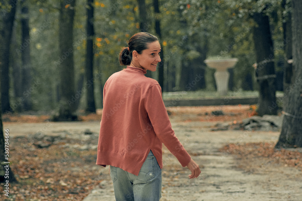 young woman in casual clothes is relaxing in an old park young woman in casual clothes is relaxing in an old park