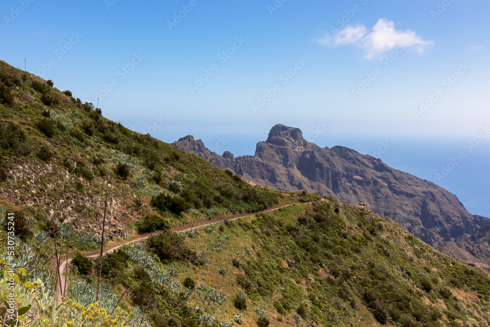 Coastal hiking trail through the Teno mountain massif, Tenerife, Canary Islands, Spain, Europe. Path leading to remote mountain village Masca. Scenic view of Atlantic Ocean and unique rock formations