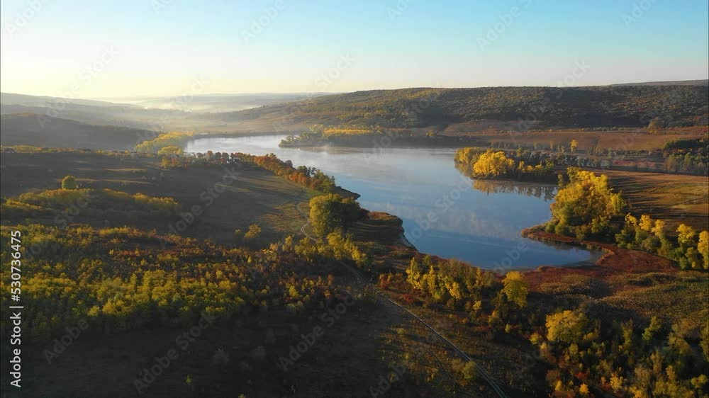 aerial view of beautiful autumn fall morning above lake with trees with yellow leaves aerial view of beautiful autumn fall morning above lake with trees with yellow leaves