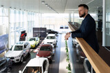 businessman chooses a new executive class car in a dealer showroom, Concept car leasing