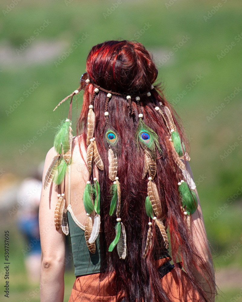 Girl with feathers in her hair. Girl with feathers in her hair.