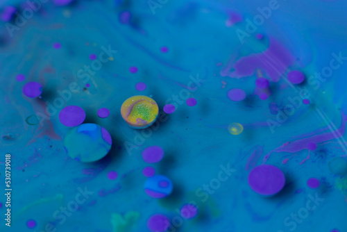 Circles yellow and purple, on fluid blue background