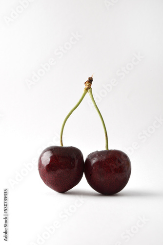 Detail of two cherries on white background