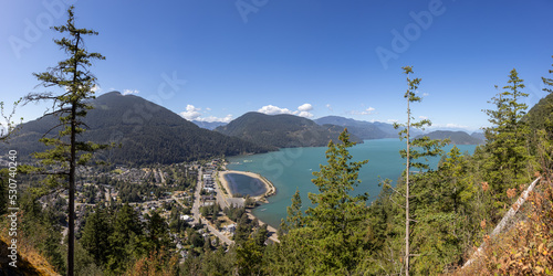 Panoramic View of Small touristic town by the lake with Canadian Mountain Landscape. Sunny Summer Day. Harrison Hot Springs, British Columbia, Canada. Panorama