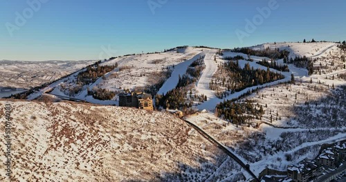 Park City Utah Aerial v18 beautiful winter landscape, drone uphill flyover deer valley resort hilltop ski lodge capturing pristine and idyllic mountain view - Shot with Mavic 3 Cine - February 2022 photo