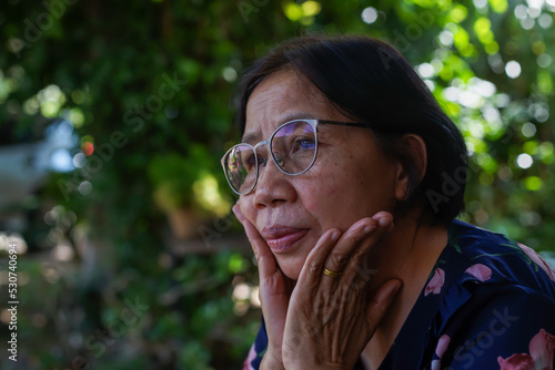 elderly woman sitting sad face