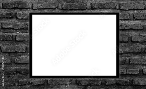 Mockup white picture frame on black brick wall background with clipping path