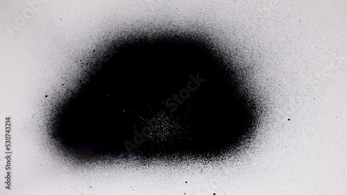 Black spray paint on a white background. Overlay.