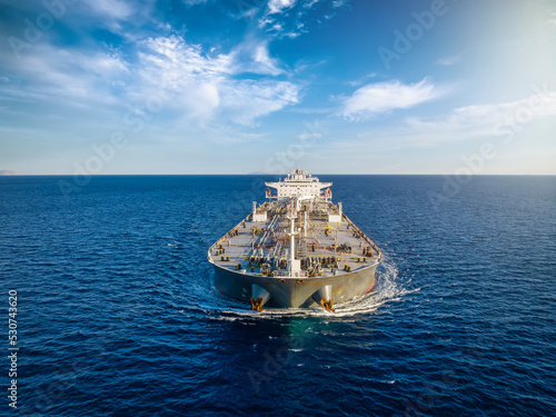 Fotografie Aerial front view of a heavy loaded oil cargo tanker in motion over blue ocean